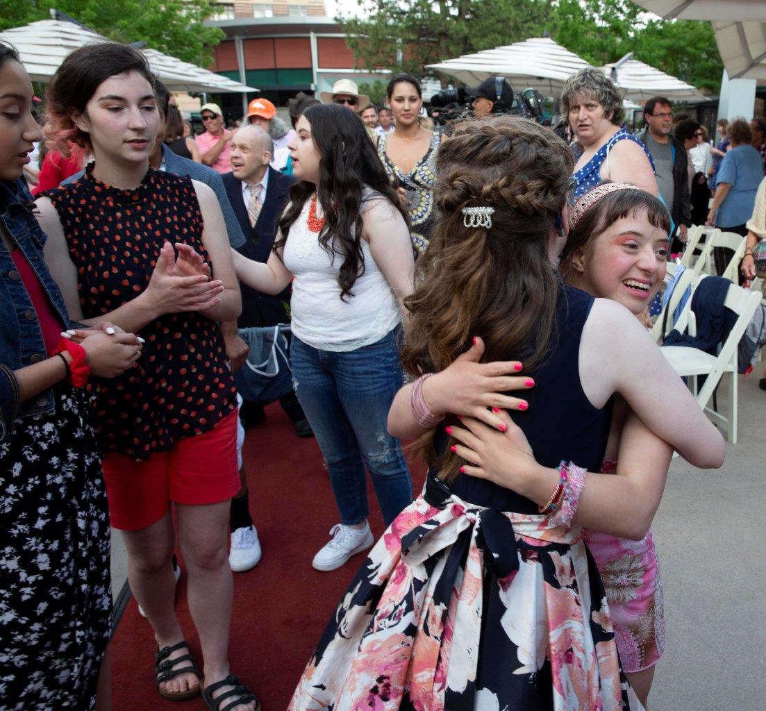 Phoebe Kochis and Cynda Murrow hug, with  Boys & Girls Club models nearby